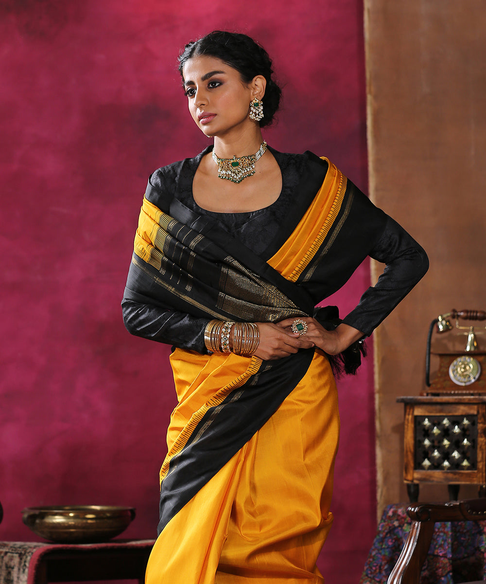 Handloom_Mustard_Plain_Pure_Silk_Kanjivaram_Saree_With_Black_Border_WeaverStory_01