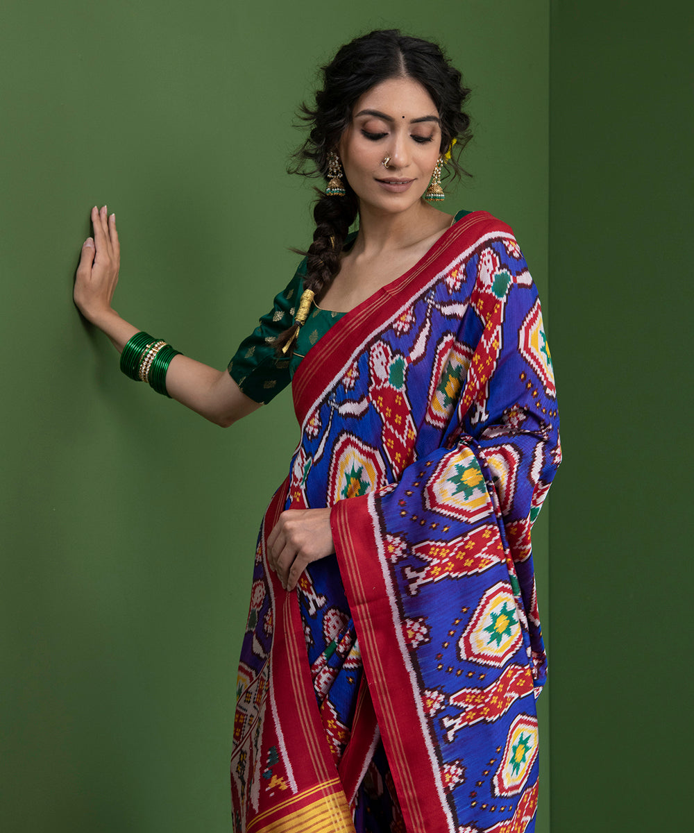 Blue_Weft_Dyed_Handloom_Patola_Saree_With_Red_Border_And_Village_Woman_Motifs_WeaverStory_01
