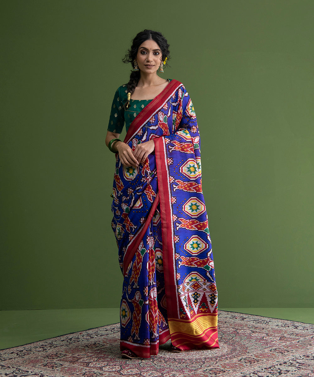 Blue_Weft_Dyed_Handloom_Patola_Saree_With_Red_Border_And_Village_Woman_Motifs_WeaverStory_02