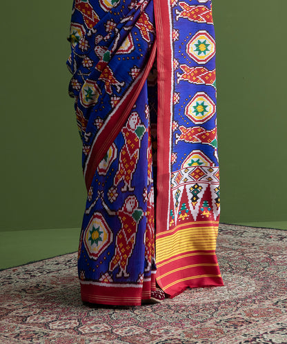 Blue_Weft_Dyed_Handloom_Patola_Saree_With_Red_Border_And_Village_Woman_Motifs_WeaverStory_04