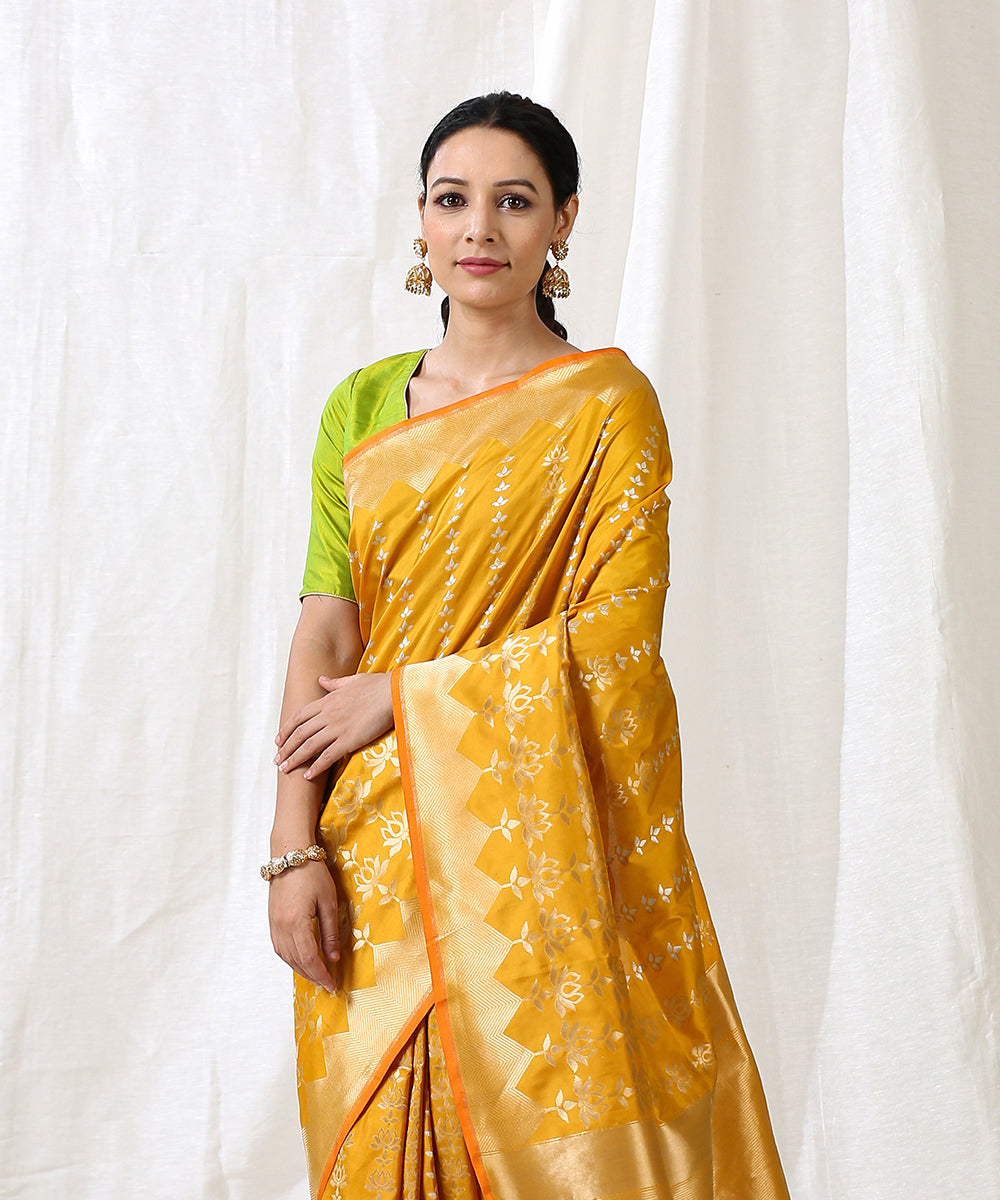 Handloom_Mustard_Pure_Katan_Silk_Banarasi_Saree_With_Lotus_Motifs_Woven_Vertically_WeaverStory_01