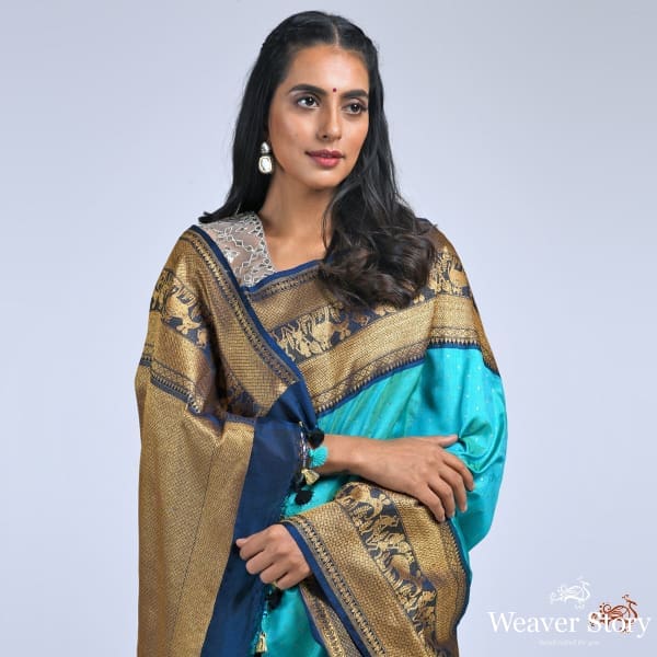 Teal_green_ektara_saree_with_navy_border_with_warli_art_weave_WeaverStory_01