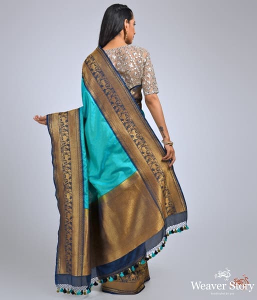 Teal_green_ektara_saree_with_navy_border_with_warli_art_weave_WeaverStory_04