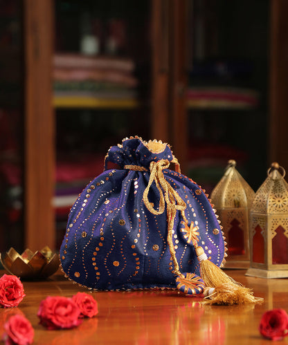 Blue_Raw_Silk_Hand_Embroidered_Potli_With_Golden_Sequin_Work_And_Tassels_WeaverStory_01