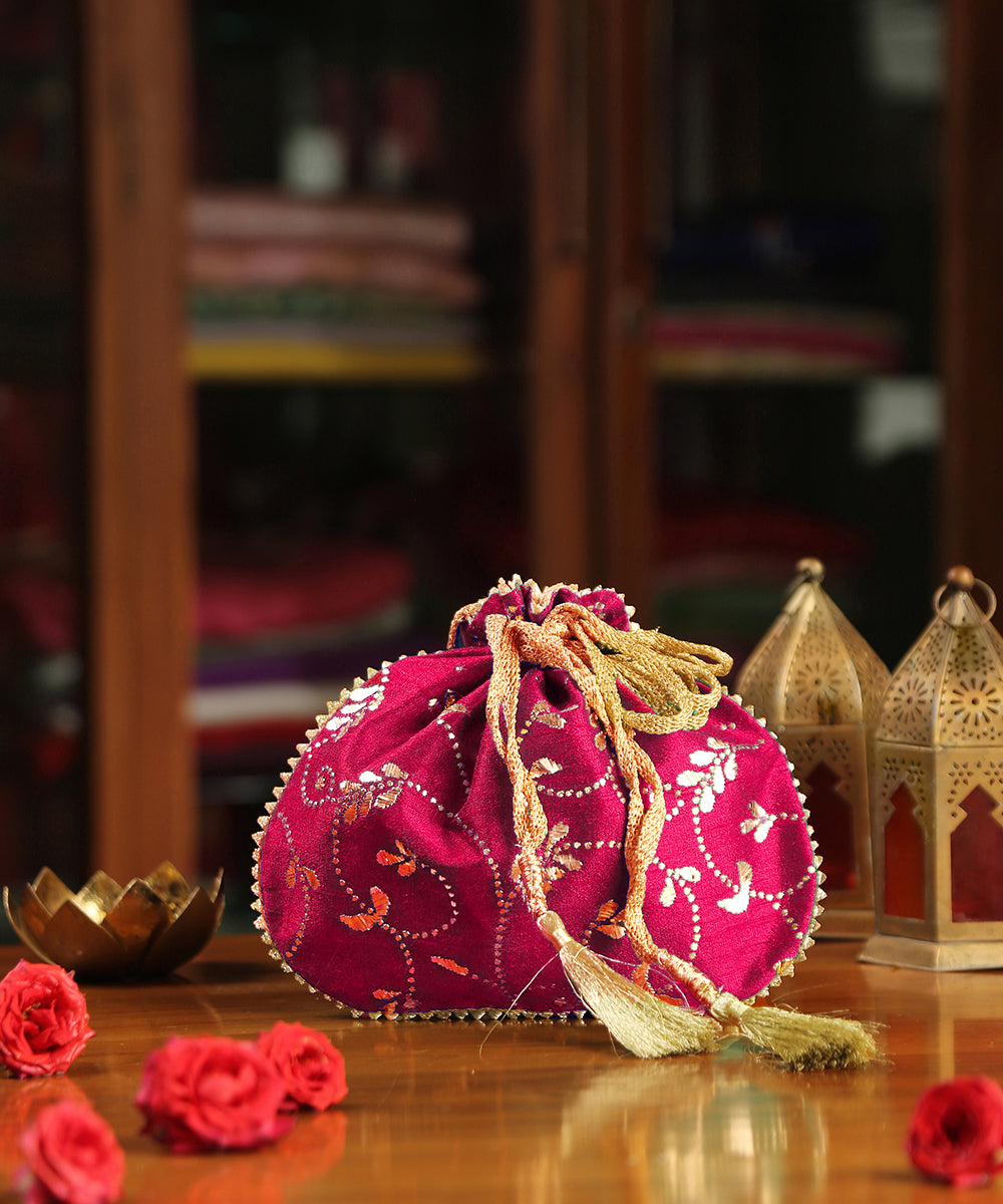 Magenta_Hand_Embroidered_Raw_Silk_Potli_With_Golden_Bel_And_Leaf_Work_WeaverStory_01
