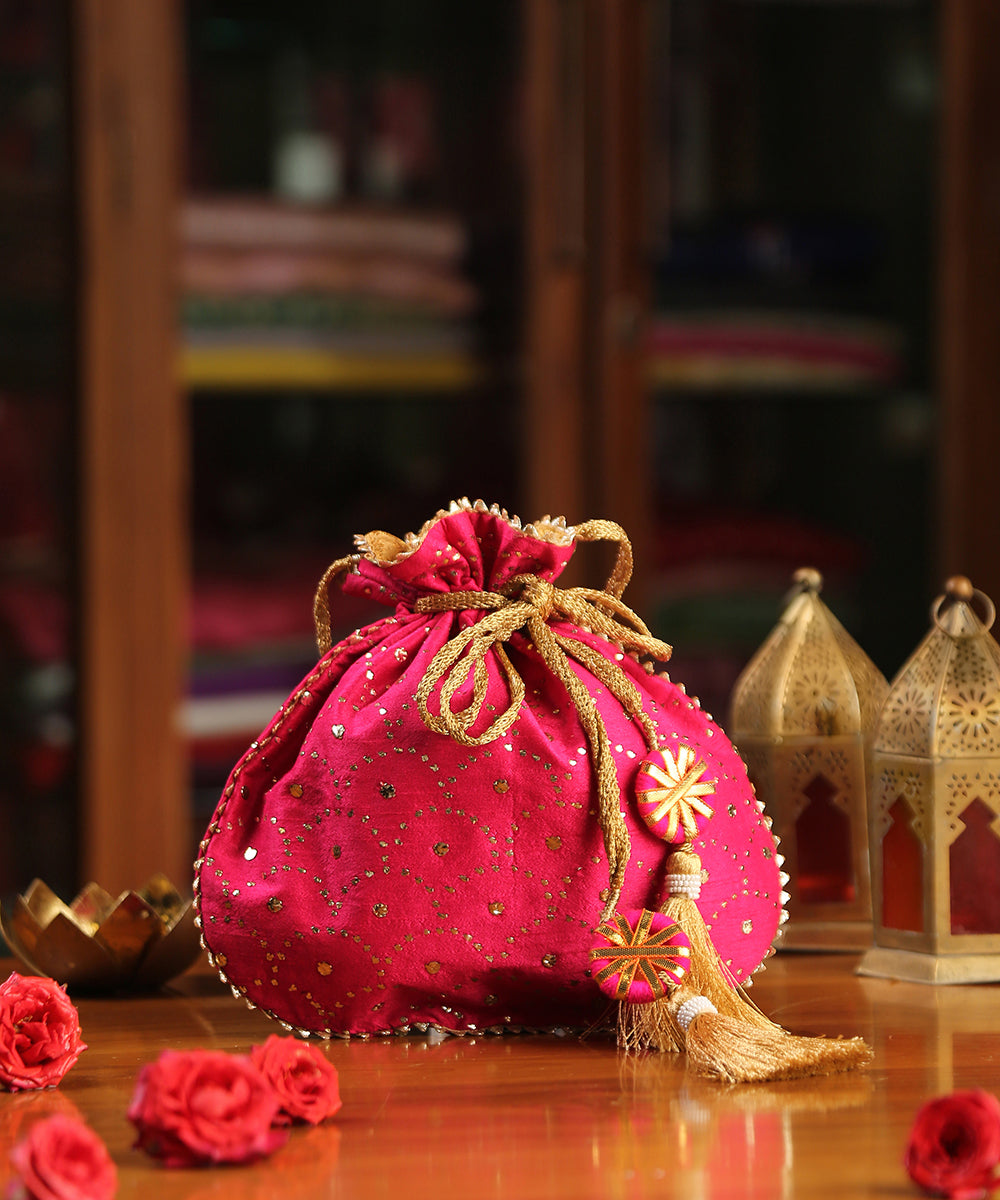 Magenta_Raw_Silk_Hand_Embroidered_Potli_With_Golden_Sequins_All_Over_WeaverStory_01