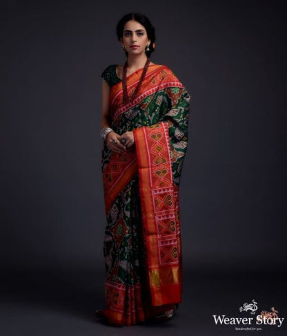 Pure_silk_Gujarat_Patola_saree_in_Green_with_red_combination_and_large_fish_motifs_WeaverStory_02