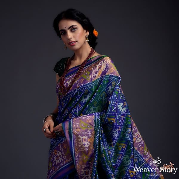 Blue_dual_tone_single_ikat_patola_saree_with_a_purple_and_gold_tissue_border_WeaverStory_01